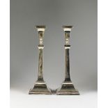 A pair of silver mounted candlesticks