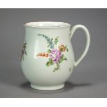 A Worcester porcelain mug painted with polychrome flowers below a puce-lined rim, circa 1775,