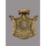 A Spanish painted gilt wood wall plaque,