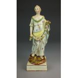 A Staffordshire pearlware figure, circa 1800-1820 modelled as a female lady in floral robe,