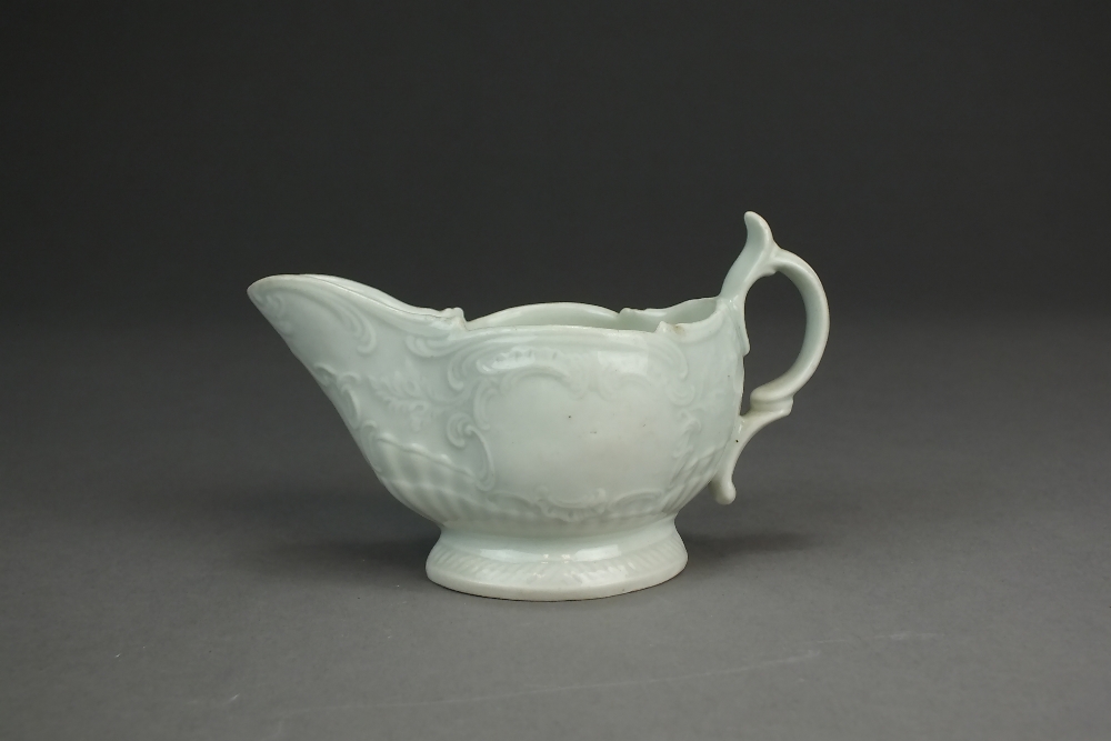 A Caughley porcelain cream jug, circa 1785-90, undecorated, with delicate relief scroll moulding,