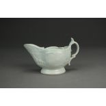 A Caughley porcelain cream jug, circa 1785-90, undecorated, with delicate relief scroll moulding,