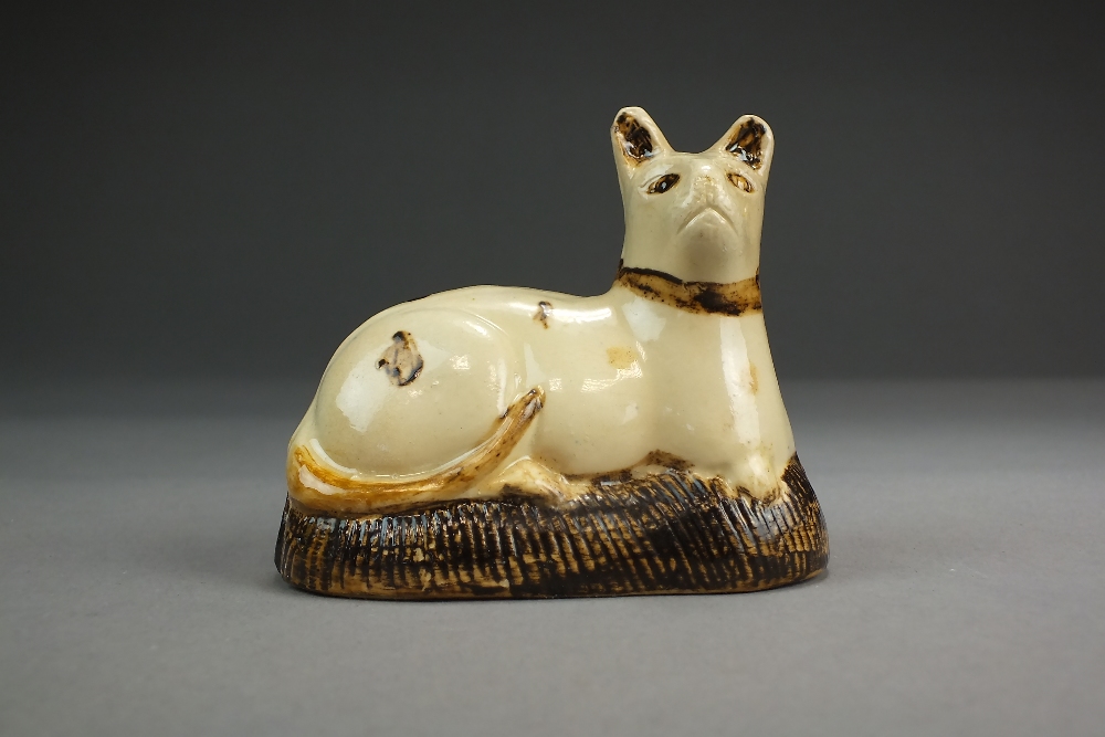 A Whieldon-type creamware model of a cat seated upon a cushion, 18th century,