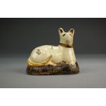 A Whieldon-type creamware model of a cat seated upon a cushion, 18th century,