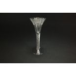 An English wine glass, circa 1770, the trumpet bowl engraved with grapes and foliate decoration,