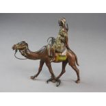 An Austrian cold painted bronze of an Arab on a camel with lime green, red and yellow detailing,