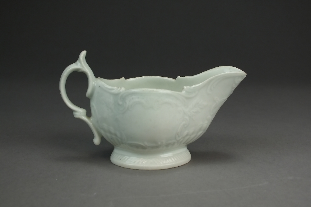 A Caughley porcelain cream jug, circa 1785-90, undecorated, with delicate relief scroll moulding, - Image 2 of 2