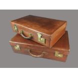 Two leather suitcases, one stamped 'Guaranteed selected hide' with lined interior, 66cm wide,