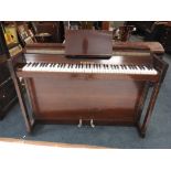 An Orpheon mahogany case upright piano with iron framed over strung action and 85 note keyboard,