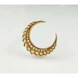 A seed pearl set crescent brooch,