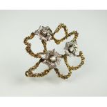 An 18ct gold diamond set brooch,