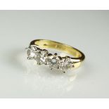 An 18ct gold four stone diamond ring,