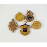 A collection of five 9ct gold Shropshire football medals, some with enamel decoration,