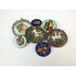 A collection of enamel coins, brooches and pendants, comprising; three crowns,