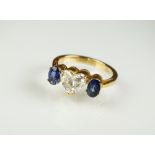 A three stone diamond and sapphire ring,