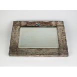 An Arts and Crafts style silver plated copper mirror,