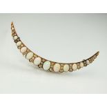 A late 19th century diamond and opal crescent brooch,