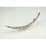 A late 19th century diamond crescent brooch,