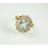 An aquamarine and diamond oval cluster ring,