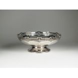 A circular pedestal silver bowl, Mappin & Webb, date mark rubbed, with pierced decorative rim, 23.