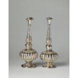 A pair of white metal Indian rosewater sprinklers, each with bulbous body,