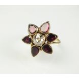 A diamond and garnet floral cluster ring,