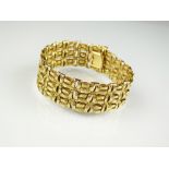 An 18ct yellow gold bracelet, of textured openwork design, hallmarked London 1970,