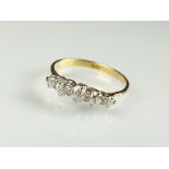 A graduated diamond ring, the five old cut diamonds claw set in white metal to yellow metal shank,