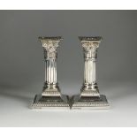 A pair of silver mounted short candlesticks, Hawksworth, Eyre & Co Ltd, Sheffield 1920,