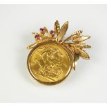 A 1968 sovereign brooch, within 9ct gold ruby set mount,