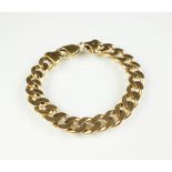 A yellow metal flat curb link bracelet, with lobster claw clasp, stamped '375', 20cm long,