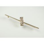 A diamond bar brooch,