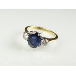 An 18ct gold three stone sapphire and diamond ring,