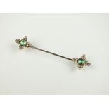 An emerald and diamond stick pin,