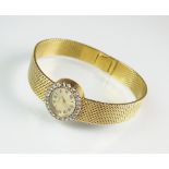 A Lady's 18ct yellow and white gold diamond set Piaget bracelet watch,