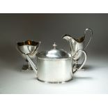 A matched three piece silver tea service, comprising; a Tiffany & Co George III style teapot, L.A.G.