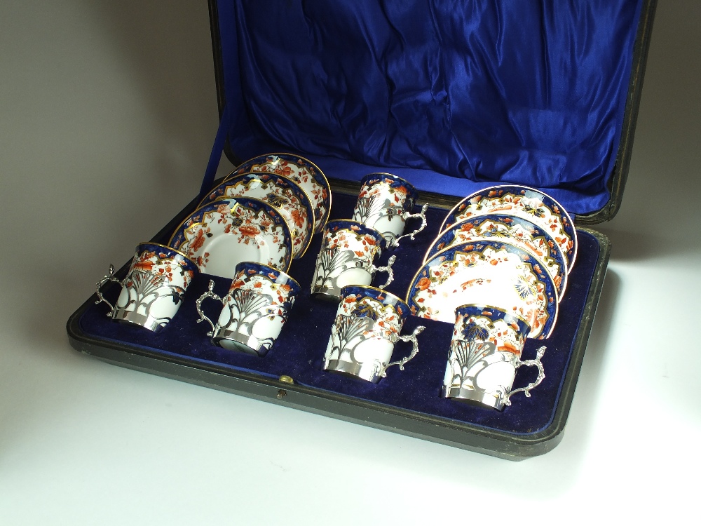 A cased set of six silver mounted Spode Copeland coffee cans and saucers, R F Mosley & Co,