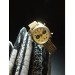 A Gentleman's 18ct gold Breitling chrono-matic bracelet wristwatch, the champagne dial with batons,