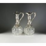 A pair of Victorian silver mounted claret jugs