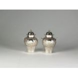 A pair of silver pepper pots