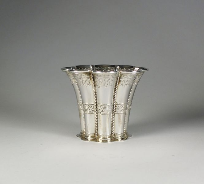 A white metal vase