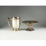 A silver mug and bon bon dish