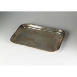 A silver dressing table tray