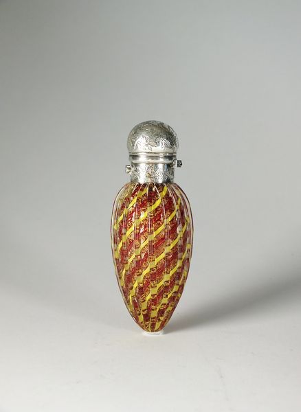 A yellow and red glass scent bottle