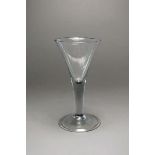 An unusually large George III wine glass with a drawn trumpet bowl above a folded foot, 23.5cm high