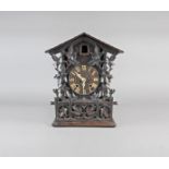 A Black Forest style stained pine case cuckoo clock, late 19 th century, the 6” dial with ivory