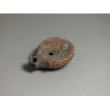 Roman, ceramic oil lamp, 2nd - 3rd century AD; angled nozzle with pelta pattern to sides, deep