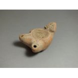 Roman, ceramic oil lamp, 2nd century AD. Double rounded nozzles with stylised pelta pattern to