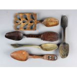 A treen carved Welsh love spoon, 19th century, the flat handle detailed with a basket of flowers,