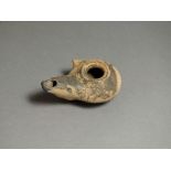 Greek, ceramic oil lamp, 5th century BC. Upward projecting nozzle; oval body with small lug to one